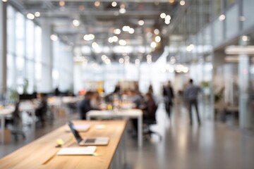 Obraz premium Blurred background of a bright, modern office interior with people working. High quality