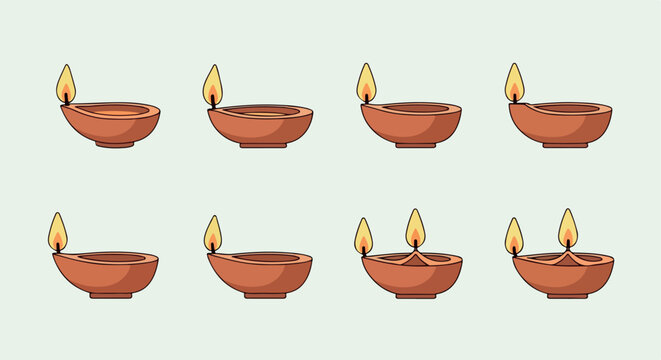 Clay diyas with flames for Diwali celebration