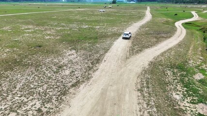Drone Tracking Shot of a Car Driving Freely on the Vast Dry Bed of Dalong Lake, China