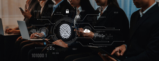 Diverse business professionals engage with technology in a modern setting, highlighting digital security and fingerprint authentication for data protection and innovation. Trope