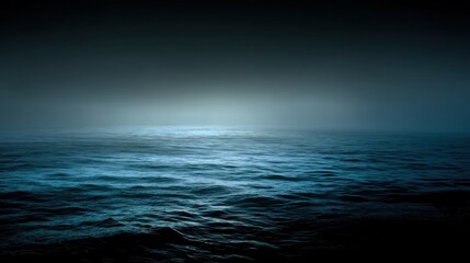 Obraz premium A dark, mysterious ocean with a faint light shining on the surface, creating a sense of depth and mystery.