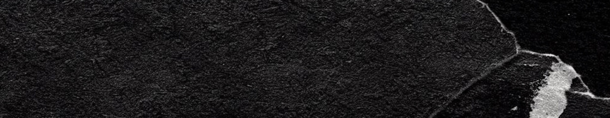 Fototapeta premium Panoramic black textured background with grainy surface and torn black paper edge detail in an elongated horizontal composition