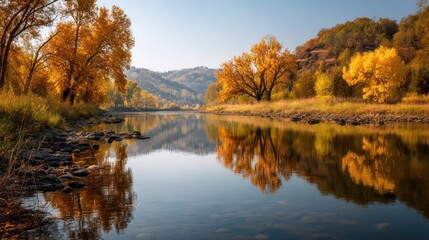 A serene autumn landscape with a calm river, colorful trees, and a clear sky, reflecting in the water.