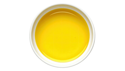 Yellow liquid fills round white bowl from overhead view