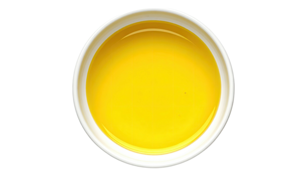 Yellow liquid fills round white bowl from overhead view