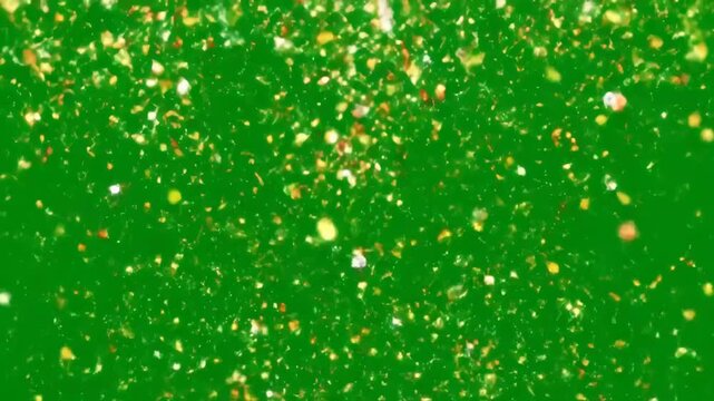 Festive Confetti Falling on Green Screen - A vibrant video showing gold and red confetti falling against a green screen background.