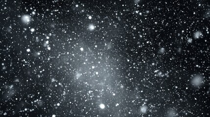 Fototapeta premium Snow falling against a black background