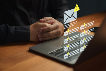 Person receiving phishing or spam email alerts on a laptop. Symbolizing data breach, email security risk, online scam detection, and protection against cyber threats. Cybersecurity concept.
