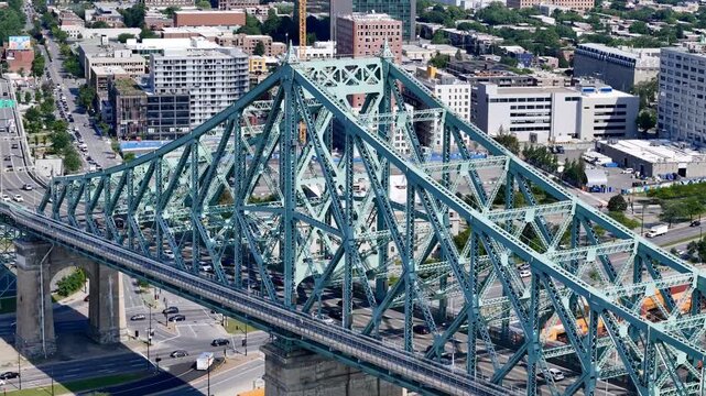 Aerial view of Montreal city skyline and the Jacques Cartier Bridge over the St. Lawrence with downtown in the background. g.