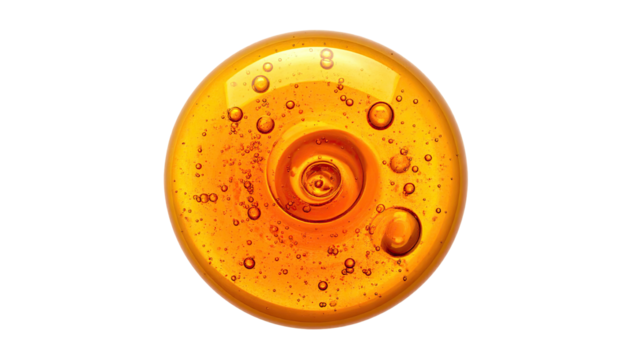 A golden orb of swirling liquid with bubbles against a stark black background