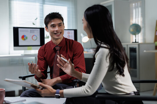 Business colleagues collaborating and discussing ideas in office