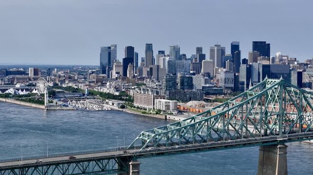 Aerial view of Montreal city skyline and the Jacques Cartier Bridge over the St. Lawrence with downtown in the background. g.