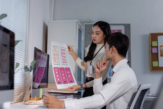Developers collaborating on user interface design mockups