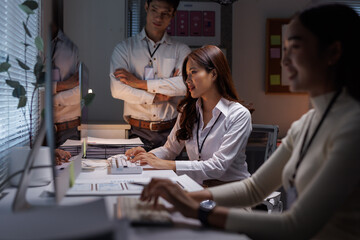 Asian business team working late night in modern office