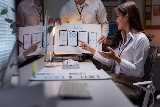 Ux ui designers collaborating on mobile application wireframes - Powered by Adobe