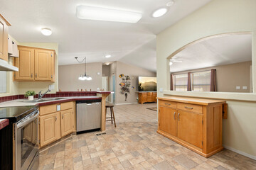A modern kitchen with stainless steel appliances and wooden cabinets