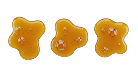 Three Golden Caramel Honey Liquid Drips or Spills Isolated on White Background