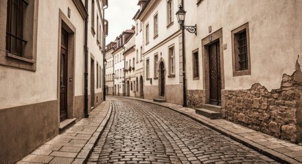 Narrow, old cobblestone street lined with historic European buildings