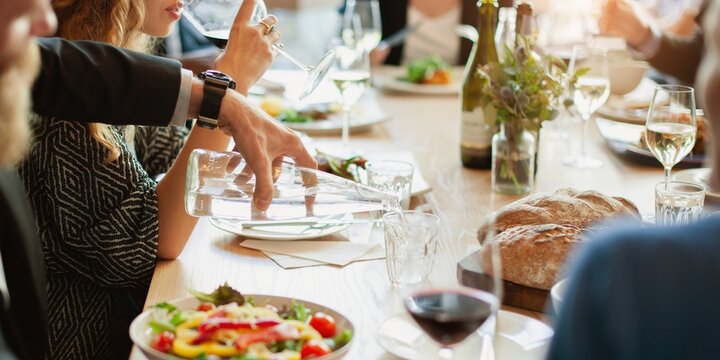 Group of diverse business people dining, business lunch. Diverse people have conversation at business lunch at restaurant. Social gathering with food and wine, diverse people group have business lunch - Powered by Adobe