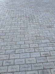 gray pavement granite tiles. paved stone sidewalk background with textured surface.