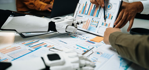 A collaborative scene showing humans and robots working together on data analysis with colorful...