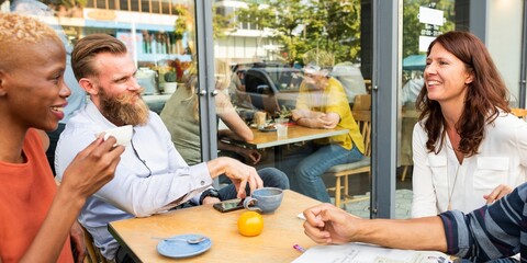 Group of diverse people enjoying coffee at an outdoor cafe. Lively conversation and laughter. Friends gathering, sharing stories, and sipping coffee together. Diverse friends in cafe.
