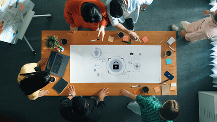 A diverse team engages in a collaborative meeting, discussing data security ideas and innovative strategies with digital tools on a large table in a modern office. Trope