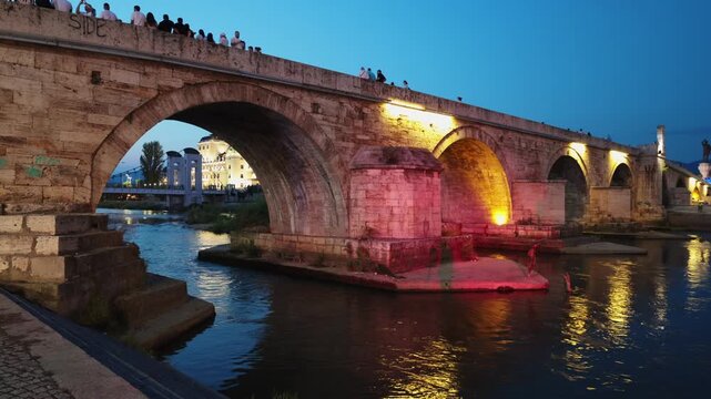Stone bridge over Vardar river, Skopje. Urban construction and city infrastructure in Central Municipality in capital of Macedonia, evening.