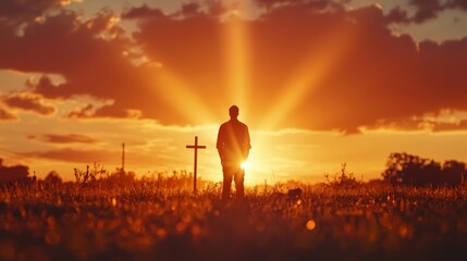 Fototapeta premium Seeking Solace at Sunset: A lone individual stands silhouetted against a radiant sunset, finding comfort and contemplation in the presence of a cross, evoking a sense of faith and serenity.