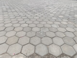 Hexagonal paving blocks. grey geometric ground pattern texture.Grey geometric pattern of concrete paving stones.Repeating pattern of hexagonal pavers on public ground.