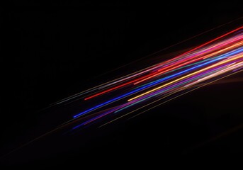 Dynamic, colorful light streaks painted against a deep black background, creating an energetic flow of abstract lines and vibrant photographic motion blur ,photography ,design ,graphic