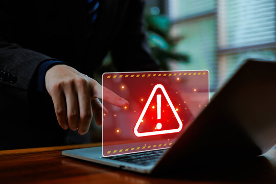 Cyber ​​attack alert on laptop. Cyber ​​attack on computer network. Virus, spyware, malware or malicious software. Businessman background.