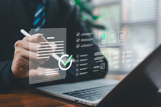 A business professional reviewing and marking digital checklist documents on a laptop with floating interface elements, symbolizing task management, approval workflow, productivity, and modern digital