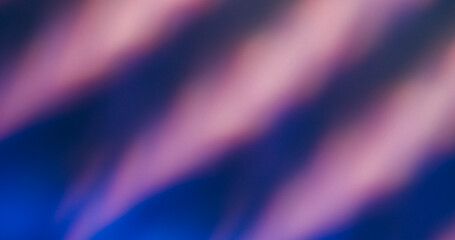 Blur light leak. Neon luminosity. Purple bright striping kaleidoscopic pattern on dark blue abstract background. Prism color art ray effect.