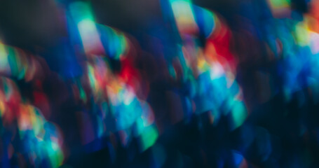 Bokeh prism. Rainbow leak. Spectrum defocused kaleidoscopic glow on abstract black background. Red blue green colorful flash texture.