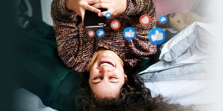 Teenage girl using a smartphone on a bed social media and addiction concept - Powered by Adobe