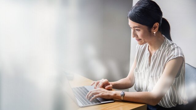 Japanese woman working on a laptop
