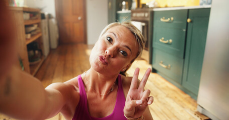 Woman, fitness and selfie with peace sign, home and happy with pout, portrait or post on web. Person, exercise and influencer with symbol, photography or profile picture for social media in Spain