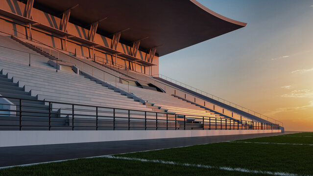Modern stadium grandstand with empty white seats and a green field at sunset, showcasing contemporary sports architecture.