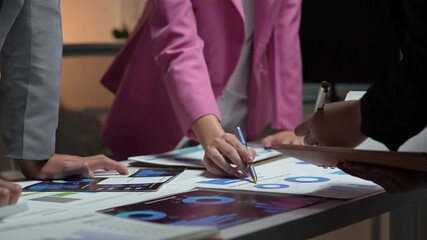 Business team analyzing financial data charts during meeting - Powered by Adobe