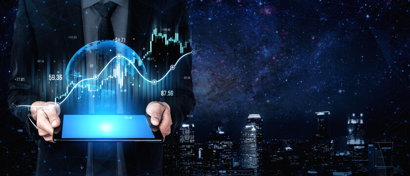 A businessman stands holding a tablet, displaying a financial graph against a city skyline at night, symbolizing data analysis and modern economic insights. Scalp
