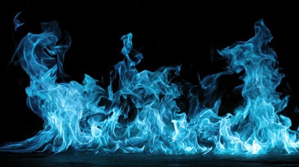 Intense blue flames burning on a dark surface against a black background fire heat
