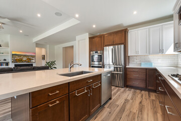 A modern kitchen with stainless steel appliances and wooden cabinets