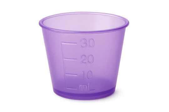 Purple plastic medicine measuring cup on transparent background