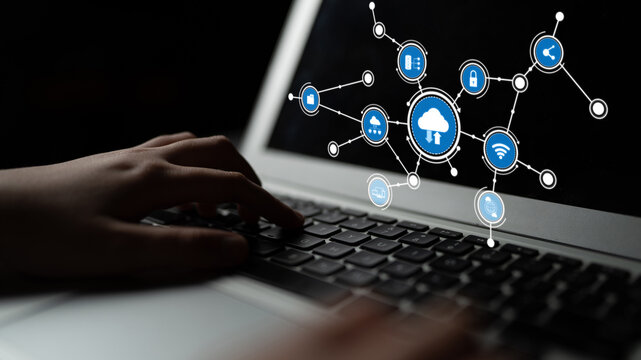 Hands typing on laptop keyboard with digital icons depicting cloud technology and network connections, representing modern digital communication and innovation. Tessel