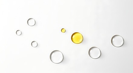 Abstract composition of clear and yellow capsules on a white background