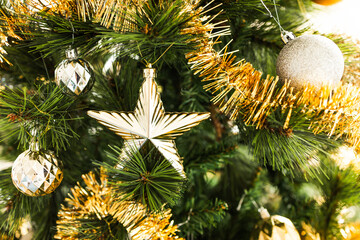 christmas tree with gold and silver decorations including stars and tinsel