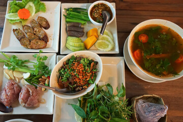 Assorted Northern Thai food- Local sausage, Chili paste, Fermented pork with egg, Star gooseberry curry soup and spicy minced pork salad