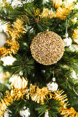 christmas tree with gold and silver decorations including stars and tinsel