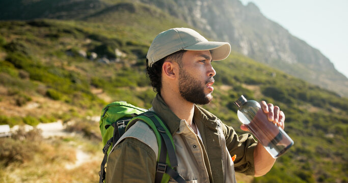 Mountain, water break and man with bottle for hiking pause, hydration and refreshing drink for workout. Outdoor, wellness and person relax on sightseeing trip, summer trekking and thirsty for liquid